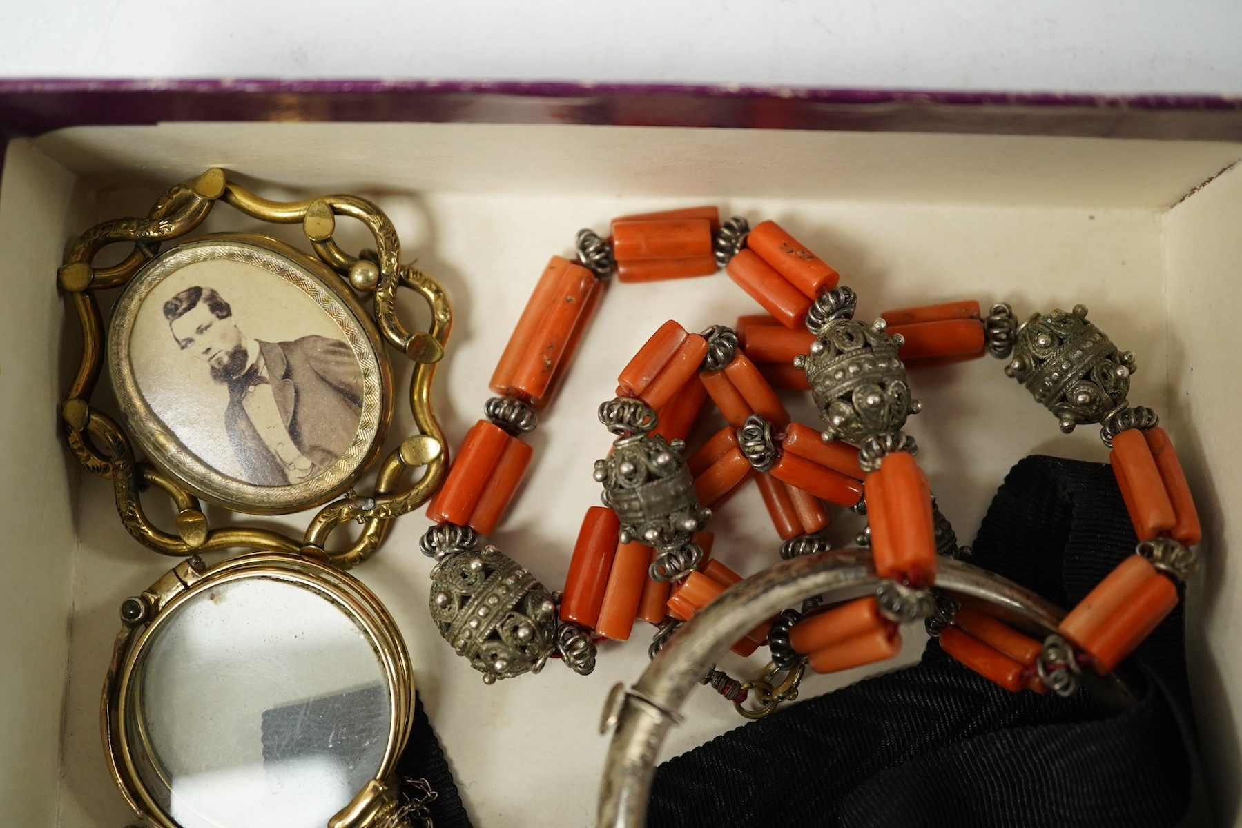 A small collection of mainly antique jewellery including coral beads, pair of lorgnettes, a gold plated oval locket etc. Condition - poor to fair